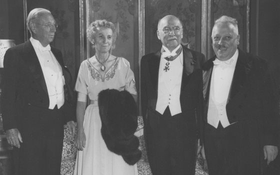 a black and white photo of a group of people in evening wear