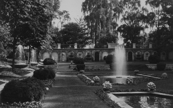 a black and white of a garden with fountains