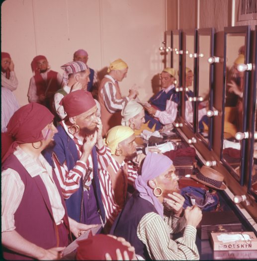 A group of actors get ready dressed as pirates in a dressing room